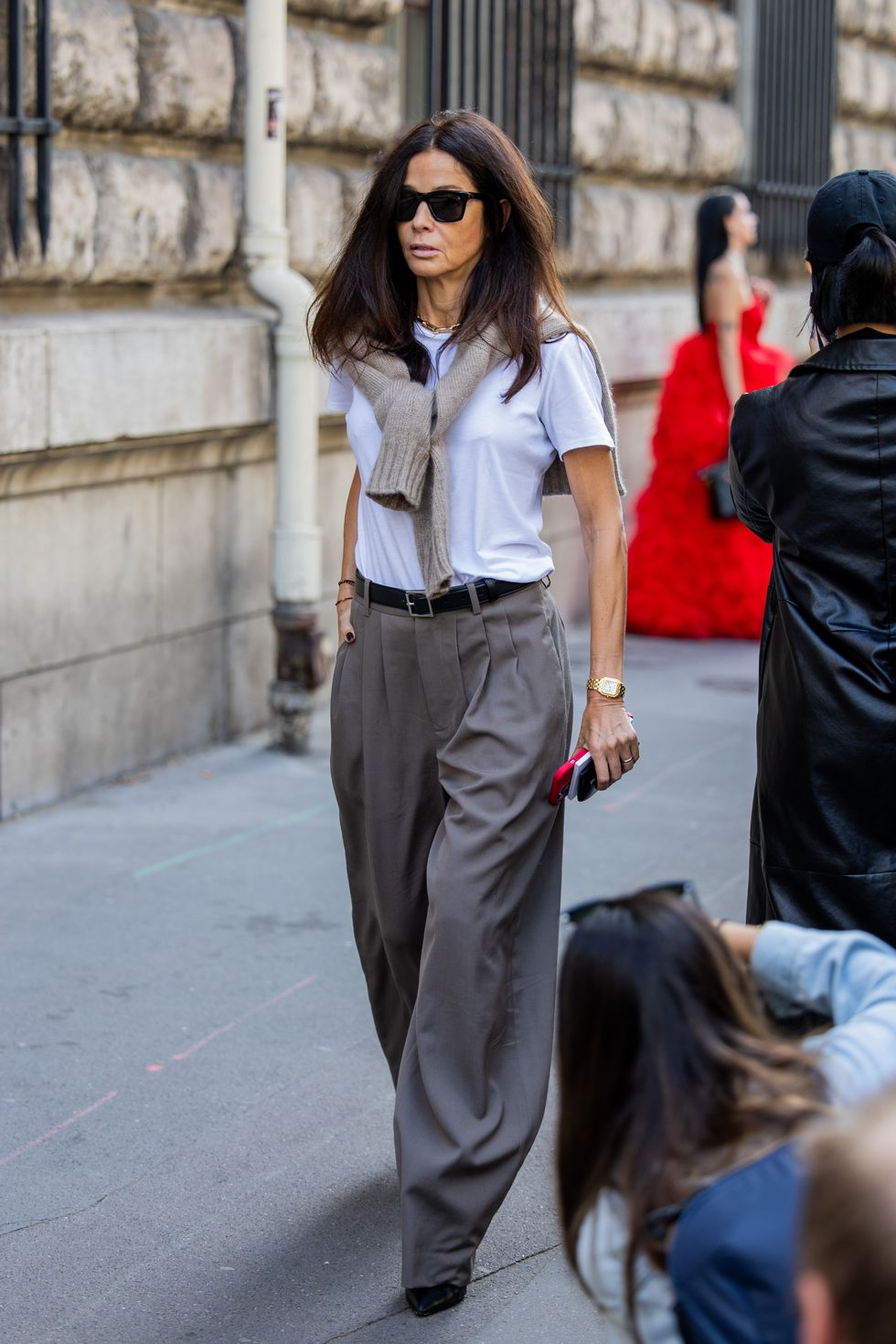Barbara Martelo wears grey wide leg pants, white shirt outside Hermes during the Womenswear Spring/Summer 2024 as part of Paris Fashion Week
