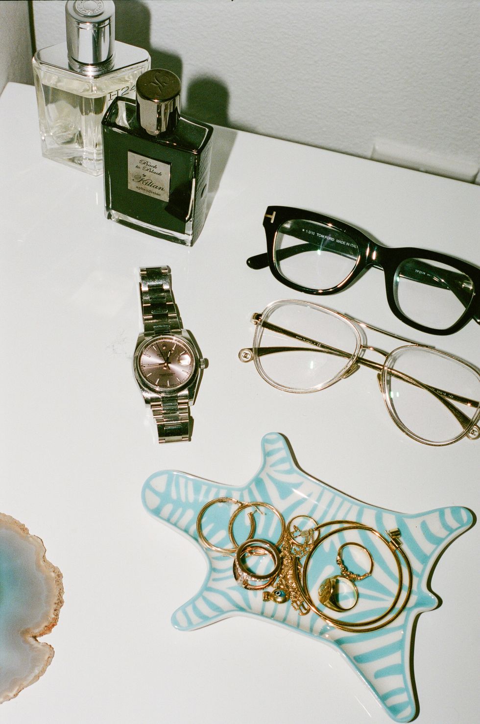 Close up of Glasses, Jewelry, and Rolex Watch