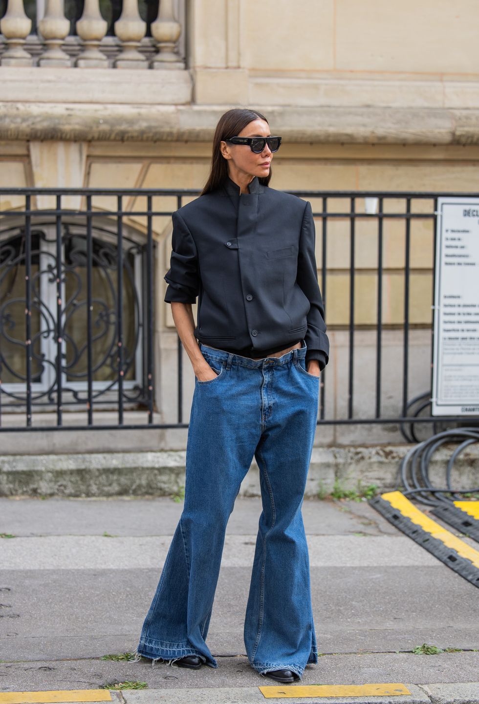 Julie Pelipas wears black jacket, wide leg denim jeans outside Carven during the Womenswear Spring/Summer 2024 as part of Paris Fashion Week