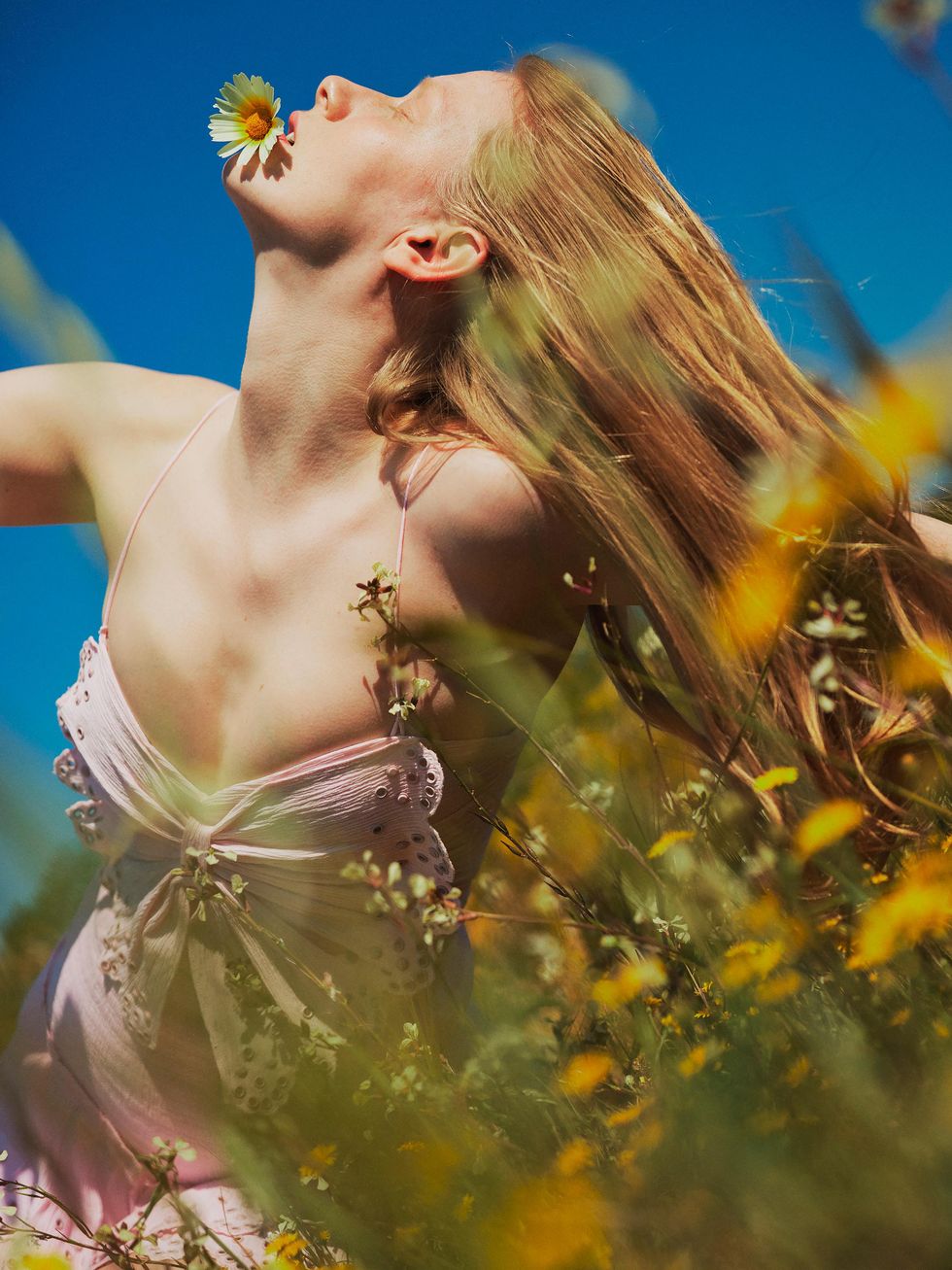 model smelling flowers