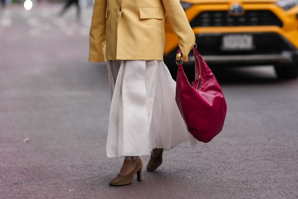 spring bag trends woman with slouchy red bag
