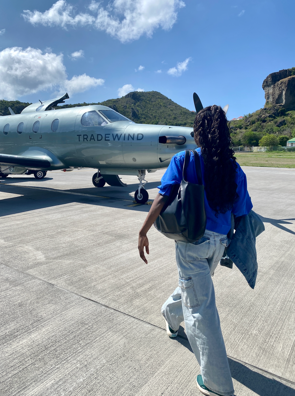 writer walking towards the small plane to fly to St. Barths
